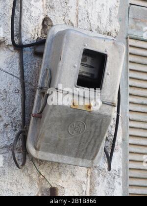 Old electricity meter on a wall in Dimitsana, Arcadia, Peloponnese, Greece Stock Photo