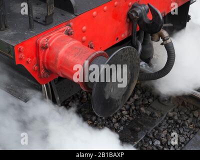 Steam train buffer . red locomottive buffer with steam emitting onto ...