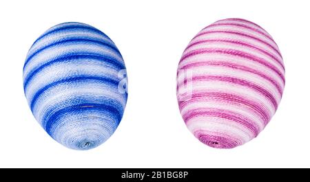 Ornate holiday Easter eggs streaked in soft blue or pink color. Beautiful egg shells hand-decorated by glued sewing cotton thread. Original decoration. Stock Photo