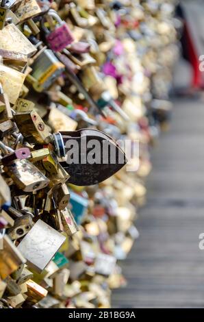 Paris, France; 07/08/2014: View the Pont des Arts. The Lovers leave padlocks. Paris is the most popular tourist destination in the world, with more th Stock Photo