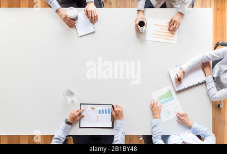Business team analyzing financial documents or working on startup project. Teamwork and meeting concept. Stock Photo