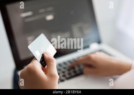 Hands holding credit card and using laptop. Online payment and shopping concepts. Stock Photo