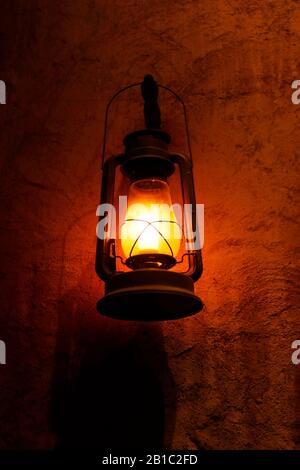 lantern lamp hanging in the night on a wall Stock Photo