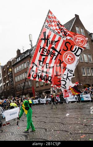 Dusseldorf, Germany. 24th Feb, 2020. Rosenmontag carnival parade in Dusseldorf, Germany. Man waving a huge flag of football club Fortuna Düsseldorf. Credit: Vibrant Pictures/Alamy Live News Stock Photo