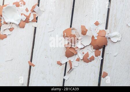 Brown egg shells on wood. Eggshell after cleaning. Stock Photo
