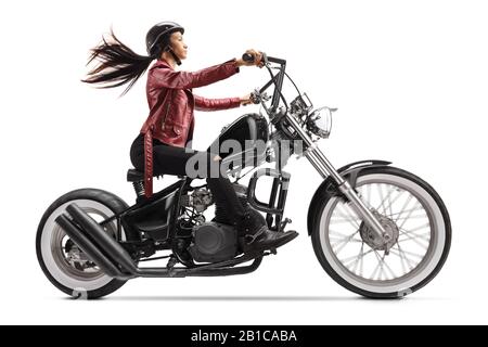 Full length profile shot of a young woman riding a custom black motorcycle isolated on white background Stock Photo