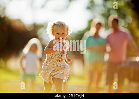 Happy siblings playing in their backyard. Stock Photo