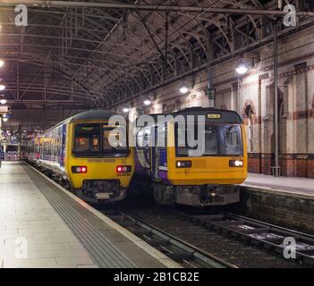 Northern rail class 323 electric train (left) and class 142 pacer train (right) at Manchester Piccadilly railway station. Stock Photo