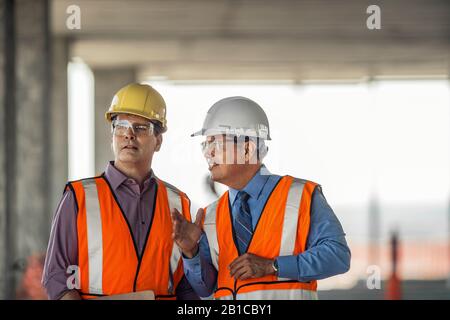 Two construction managers talking on building site. Stock Photo