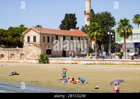 Tourists on the beach by the fort, Finikoudes, Larnaca. Cyprus. 2019 Stock Photo