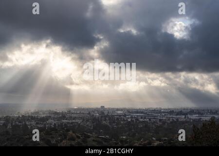 Sunrays breaking through winter storm clouds above the San Fernando Valley in Los Angeles, California. Stock Photo