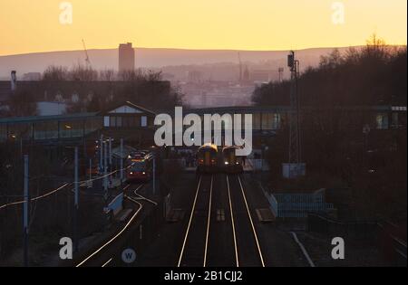 Northern Rail trains and Stagecoach Sheffield Supertram at Meadowhall interchange railway station, south Yorkshire at sunset Stock Photo