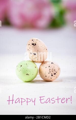 Happy Easter greeting card. Inscription, text, words. Three pastel Easter eggs on a white background Stock Photo