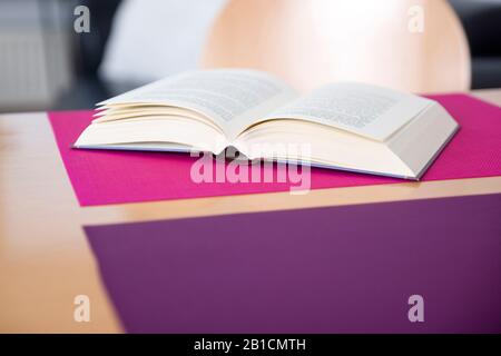 Open book lying on a table Stock Photo