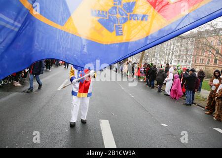 Mainz, Germany. 24th February 2020. A flag-waver waves his flag at the Mainz Rose Monday parade. Around half a million people lined the streets of Mainz for the traditional Rose Monday Carnival Parade. The 9 km long parade with over 9,000 participants is one of the three large Rose Monday Parades in Germany.