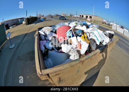 Litter and trash for disposal or recycling from homes and families with paper and plastic so as not to pollute the world and create global warming Stock Photo