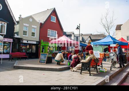 21 March 2015 Young men and women gathered around a market stall selling french Style crepes in Kinsale County Cork Ireland in early spring Stock Photo