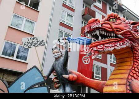 Mainz, Germany. 24th Feb, 2020. A protester from Hong Kong in the paw of a large red dragon, representing China, is depicted on a float in the Mainz Rose Monday parade. Around half a million people lined the streets of Mainz for the traditional Rose Monday Carnival Parade. The 9 km long parade with over 9,000 participants is one of the three large Rose Monday Parades in Germany. (Photo by Michael Debets/Pacific Press) Credit: Pacific Press Agency/Alamy Live News Stock Photo