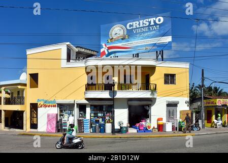 Puerto Plata, Dominican Republic - February 7, 2020:  Man drives motorized bike by Super Store in Puerto Plata. Stock Photo