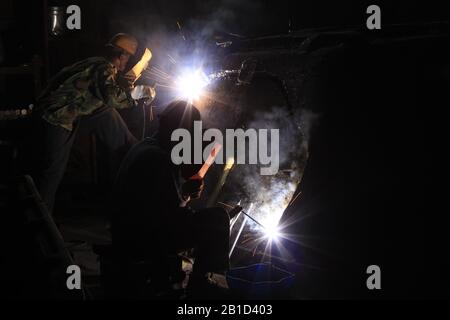 In the steel mill workshop, welding workers are working Stock Photo