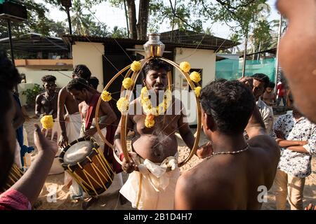 Devotees being pierced with hooks to hang as a ritualistic act of devotion, Garudan Thookkam, during Thaipooyam (Thaipoosam), Kedakulam, Kerala, India. Stock Photo