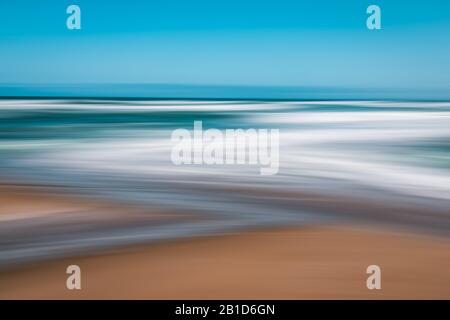 Abstract seascape background. Sandy beach and clear blue sky.  Blurred panning motion, line art Stock Photo