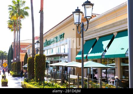 The Wholefoods Market in Fashion Island has palm trees, green awnings, and decorative lamps at the storefront.  Newport Beach, California. Stock Photo
