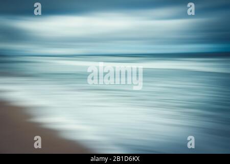 Abstract seascape. Blue hour on the beach. Blurred panning motion, line art, blue colors Stock Photo