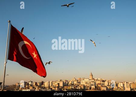 The Galata Tower during the golden hour under a cloudy sky in Istanbul ...