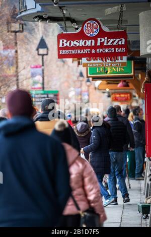 BANFF, CANADA - FEB 15, 2020 : Boston Pizza sign on busy Banff Avenue in Alberta, Canada. The Canadian restaurant chain, also known as BP and The Gour Stock Photo