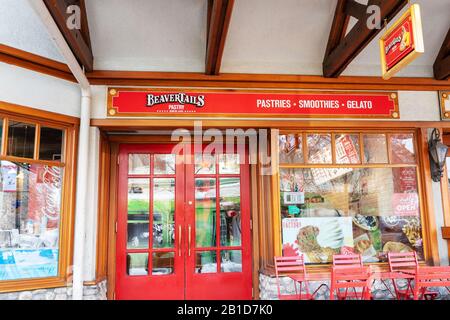 BANFF, CANADA - FEB 15, 2020 : Famous Canadian-based BeaverTails restaurant with its sign on busy Banff Avenue in Alberta, Canada. Stock Photo
