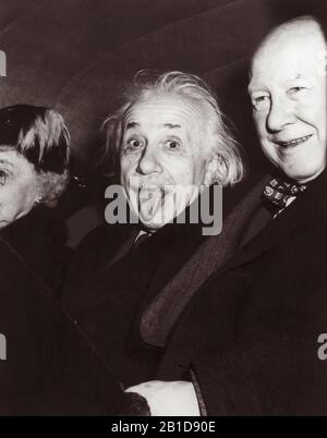 Iconic photo of Albert Einstein sticking out his tongue on the occasion of his 72nd birthday party at Princeton University on March 14, 1951. Photographer Arthur Sasse captured the split-second image as Einstein was leaving the event, seated in the back seat of a car between Dr. Frank Aydelotte, former head of the Institute for Advanced Study at Princeton University, and Aydelotte's wife, Marie Jeanette. Stock Photo