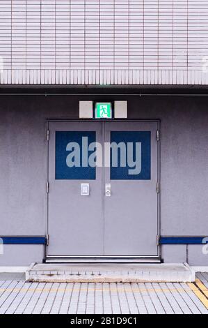 Modern building Emergency Exit with metal iron door with fire exit sign above doorway Stock Photo
