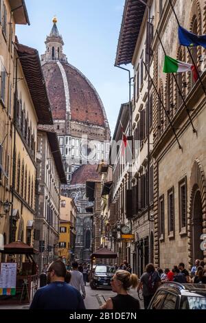 Looking down a busy street in Florence, Italy towards the towering Florence Cathedral. Stock Photo