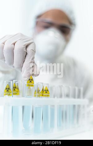Silhouette of serious medical worker that taking test tube