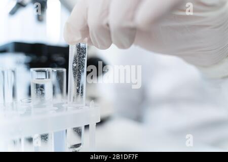 Focused photo on hand that taking test tube