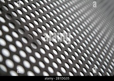 Perforated metallic grid, industrial background. Steel plate with holes. Stock Photo
