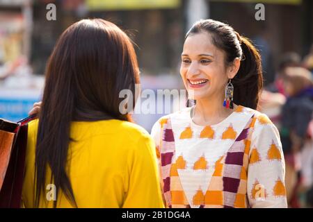 Two women having fun at Surajkund Mela Stock Photo