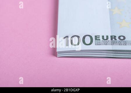 Euro cash on a lilac, purple and pink background. Euro Money Banknotes. Euro Money. Euro bill. Place for text Stock Photo
