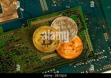 Bitcoin king of crypto currency on a computer background, Gold, Bronze and Silver Stock Photo