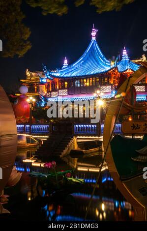 Yuyuan’s Huxinting seen through a gap in Chinese New Year decorations at night. Stock Photo