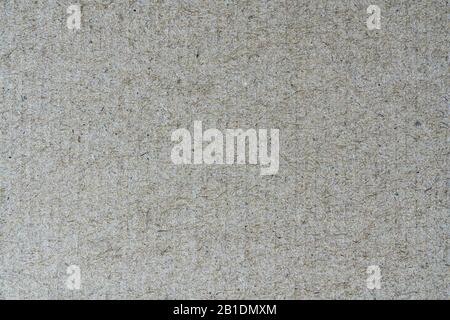 Light brown background from sheet of recycled cardboard. Close-up detail view of abstract texture recycled eco-friendly material pattern background Stock Photo