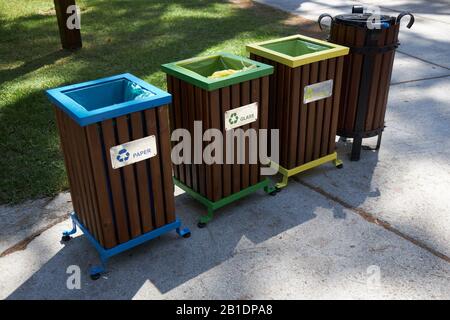 Recycling bins of different colors for separate collection of garbage for the purpose of subsequent processing. Stock Photo
