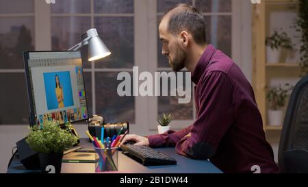 Bearded professional photographer working in editing app. Software for retouching. Stock Photo