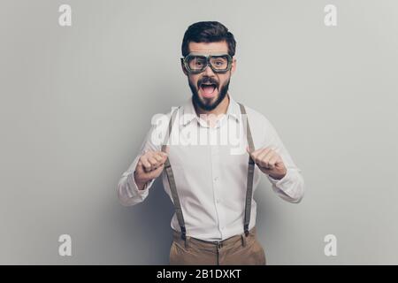 Portrait of astonished funky man have safety flight goggles ready launch plane fly pull suspenders wear good look outfit isolated over grey color Stock Photo