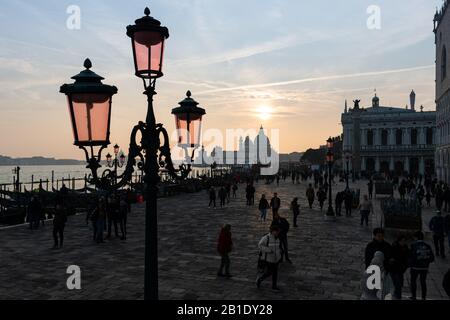 Lanterns in front of sunset behind Santa Maria della Salute in Venice (Italy) Stock Photo