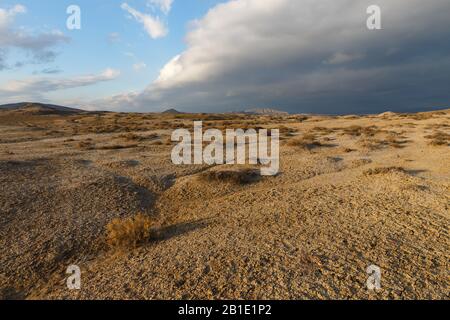 Mud volcanoes of Gobustan near Baku, Azerbaijan. mud volcanic landscape against a stormy sky Stock Photo