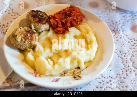 Close up view rustic nutritious meal of mashed potato and cutlets in plate Stock Photo