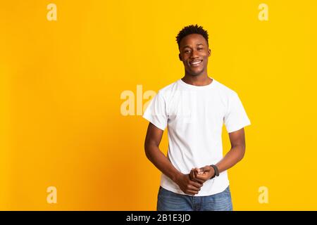 Charming young african man in casual wear widely smiling Stock Photo