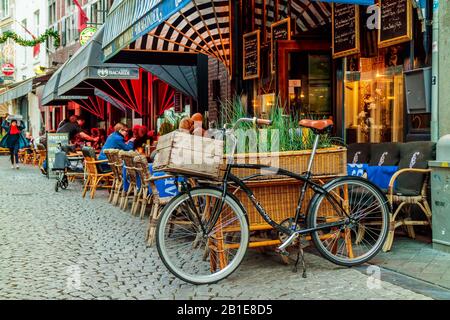 MAASTRICHT, THE NETHERLANDS - NOVEMBER 22, 2016: People sitting in front of bars and restaurants in the city center of Maastricht, The Netherlands Stock Photo